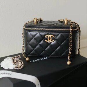 Chanel small black quilted lambskin chain cosmetic bag